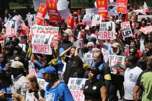 OAK BROOK, IL - MAY 21: Fast food workers and activists demonstrate outside the McDonald's corporate campus on May 21, 2014 in Oak Brook, Illinois. The demonstrators were calling on McDonald's to pay a minimum wage of $15-per-hour and offer better working conditions for their employees. Several protestors were arrested after they entered and ignored police orders to leave the McDonald's campus. McDonald's is scheduled to hold its annual shareholder's meeting tomorrow at the campus. (Photo by Scott Olson/Getty Images)